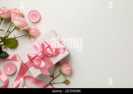 Concept of Valentines Day with roses, gift boxes and candles on pastel pink, a soft Valentines Day gift set Stock Photo