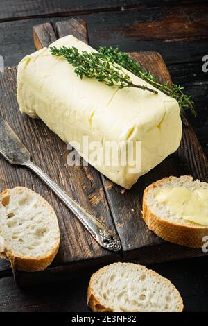 Rustic farmhouse inspired fresh butter, on old dark wooden table background Stock Photo