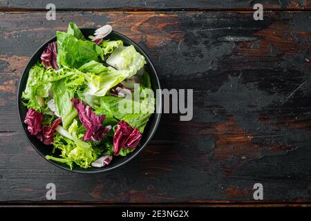 Frieze, romaine and Radicchio lettuce salad, on old dark wooden table background, top view flat lay with copy space for text Stock Photo