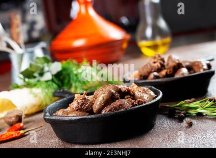 fried chicken hearts in pan, fried hearts with salt and spice Stock Photo