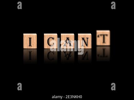 I CAN'T or I CAN Concept : I Can not vs I Can ; Conceptual motivation Blur and Selective focus on wood Blocks Focused on alphabets Stock Photo