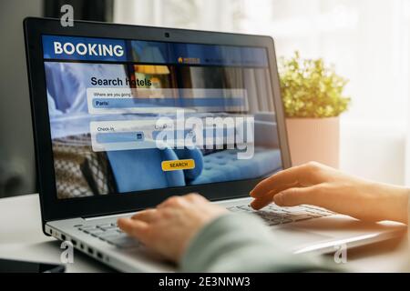 online booking - person using laptop for hotel search and reservation Stock Photo