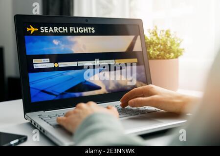 online booking - person using internet website in laptop for flight search and reservation Stock Photo