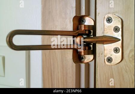 Closeup an Opened Door Guard Swing Bar of the Room Stock Photo
