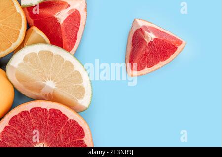 Orange, grapefruit, lemon, Mix citrus fruits. Fresh citrus fruit assortment isolated on blue. Citrus Pattern On Blue bacground. Top view flat lay copy Stock Photo