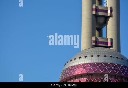 A plane behind the Oriental pearl tower in Shanghai, could be from Hongqiao or Pudong airports. Stock Photo