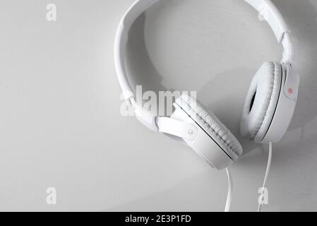 white headphones on light grey background Stock Photo