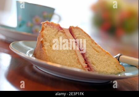 slice of victoria sponge cake and blurred background Stock Photo