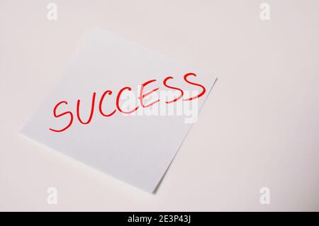 The word success written by hand and put on the white table with copy text Stock Photo