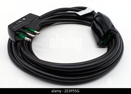 Black electric power extension cable isolated on a white background. Stock Photo