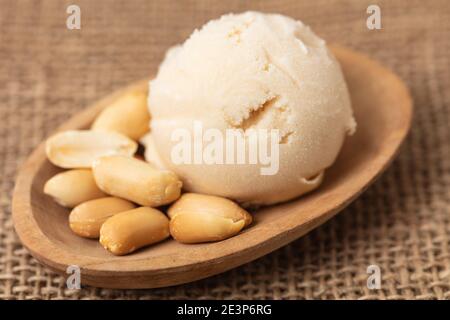 Homemade scoop of peanut ice cream or peanut butter ice cream with peanuts Stock Photo
