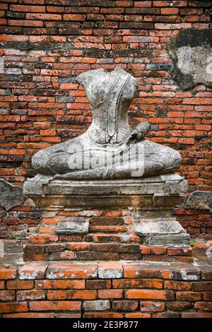 A headless stone statue of Buddha sitting in the lotus position. The statue is in a ruined Khmer tample complex. Many of the statues have been vandali Stock Photo