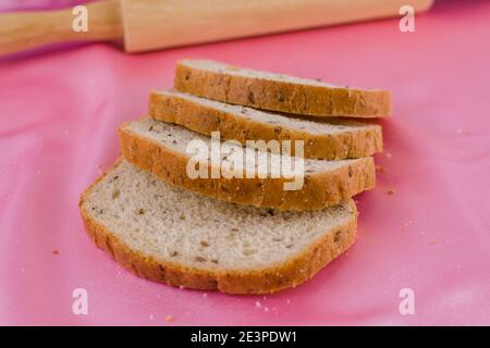 a sliced bread with a rolling pin on the cloth Stock Photo