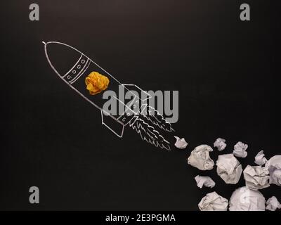 Launching rocket with jet stream of paper balls, creativity concept or new ideas metaphor, start up business , new year’s resolution Stock Photo