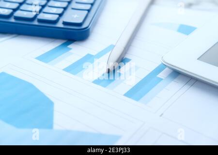 detail shot of financial graph, calculator and digital tablet on table  Stock Photo