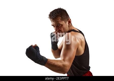 Aggressive boxer man in black sports bandages on his hands fighting isolated on white background Stock Photo