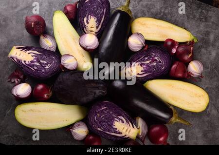 Still life of fresh purple vegetables on a gray background. Collection of fresh purple vegetables, Vegetable background Stock Photo