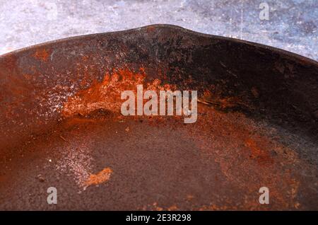 Rusty metal pans on a rustic background. Renovation of cast iron pan. Old rusty round cast iron frying pan. view from above Stock Photo