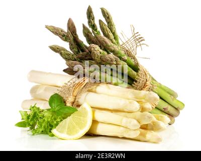 Green and White Asparagus Bundles with Lemon on white Background Stock Photo