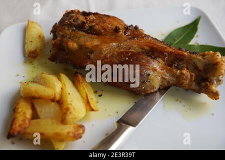 A ham hock (or hough) or pork knuckle with French fries Stock Photo