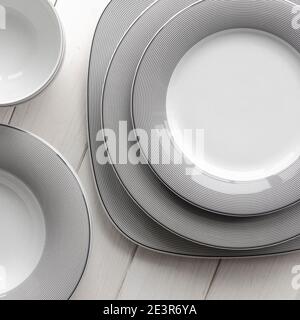For home and restaurant. A classic set of porcelain plates of different shapes and sizes Stock Photo