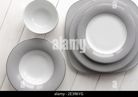 For home and restaurant. A classic set of porcelain plates of different shapes and sizes Stock Photo