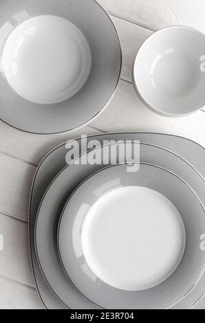 For home and restaurant. A classic set of porcelain plates of different shapes and sizes Stock Photo