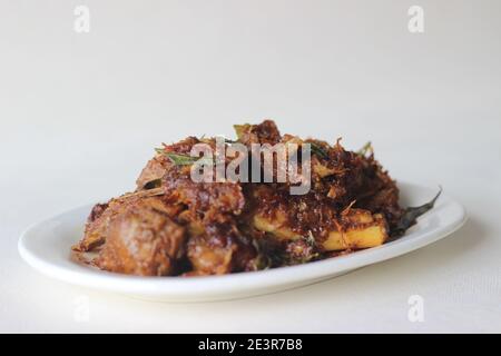 Spicy mutton roast prepared in Kerala style for special occasions like Christmas, Easter, Onam and other festivals Stock Photo