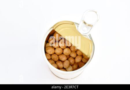 crispy sweet peanut coating coconut milk pouring from tin can packaging on white background Stock Photo