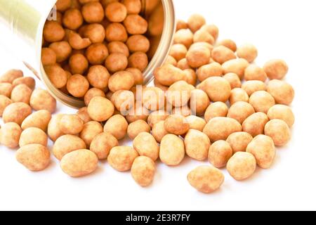 crispy sweet peanut coating coconut milk pouring from tin can packaging on white background Stock Photo