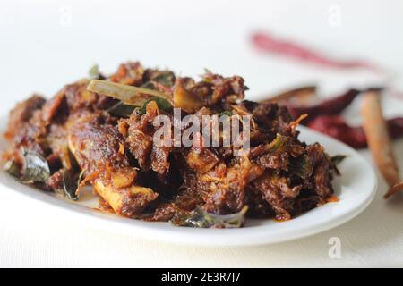 Spicy mutton roast prepared in Kerala style for special occasions like Christmas, Easter, Onam and other festivals Stock Photo