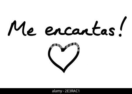 Me encantas! - meaning I Really Like You, in the Spanish language, with a heart illustration, handwritten on a white background. Stock Photo