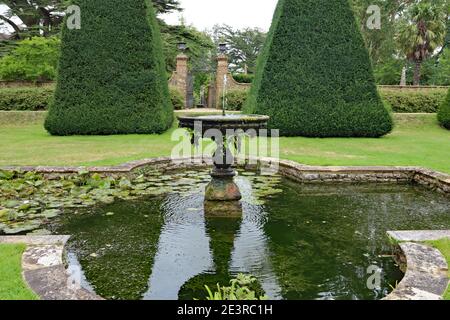 DORCHESTER, DORSET, UK - AUGUST 21ST 2020: A fountain and an ornamental pool stands in the formal garden of an English Stately Home Stock Photo