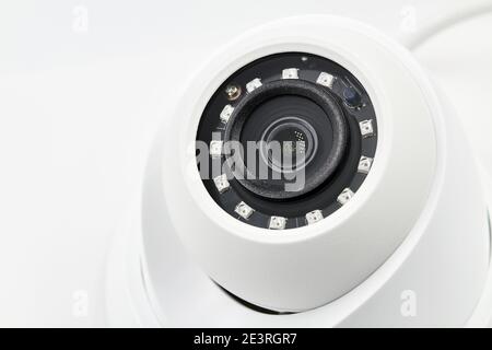 Dome secure camera on light background with motion sensors. Video surveillance camera. Closeup, selective focus. Stock Photo