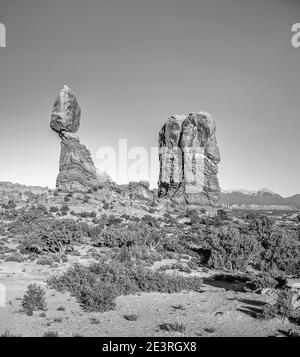 United States. Fabulous mountain-desert scenery of Balanced Rock in monochrome in Arches National Park of Utah in the United States. As seen here that was used as a movie set in the opening scenes of the Indiana Jones movie the Last Crusade that starred Harrison Ford and Sean Connery Stock Photo