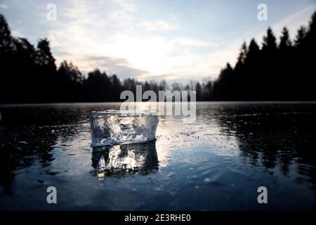 Big frozen ice cubes on an iced lake with snow and sunshine around Stock  Photo - Alamy