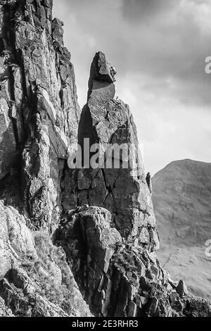 The image is of rock climbers in action scaling Napes Needle around 2000. Napes Needle is a rock formation on the side of Great Gable mountain at the head of the Wasdale  valley in the English Lake District being a popular objective as a right of passage for rock climbers of every generation Stock Photo