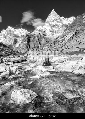 Nepal. Himalayan mountains in monochrome in the Sagarmatha National Park of the Solu Khumbu valley of Mount Everest in Nepal, With one of the many un-named peaks seen en-route to Mount Mera. Stock Photo