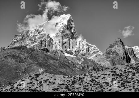 Nepal. Himalayan mountains in monochrome in the Sagarmatha National Park of the Solu Khumbu valley of Mount Everest in Nepal, With the modest peak of Taweche seen here from above Periche en-route to the Everest mountaineering base camp. Stock Photo