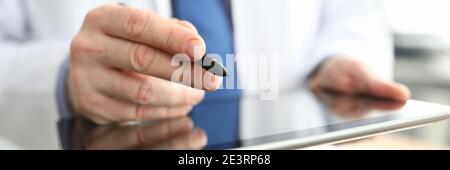 Doctor making notes on graphics tablet close up Stock Photo