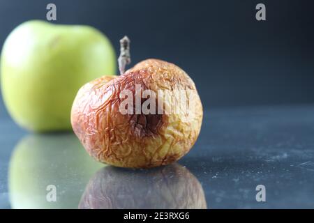 apple ugly spoiled and beautiful good on a black background copyspace. Stock Photo