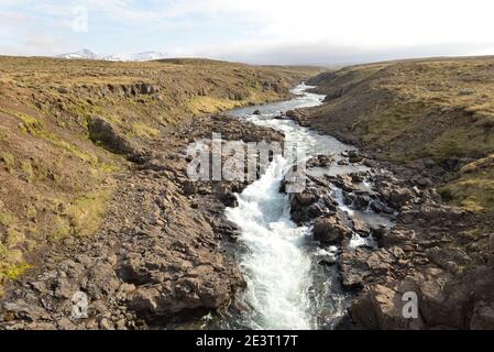 Stream flowing through lava field in Iceland Stock Photo