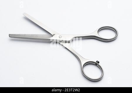 Pair of hair thinning scissors on white background Stock Photo