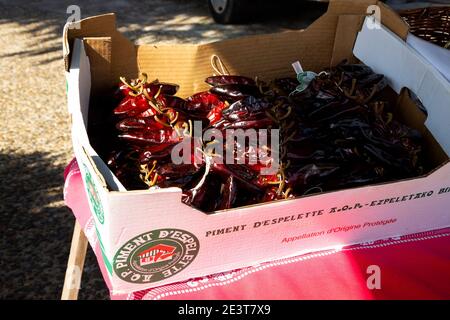 ESPELETTE, FRANCE - AVRIL 19, 2018:  Espelette peppers, kind of chilli pepper named after the French town where it's grown, for sale. Traditionally us Stock Photo