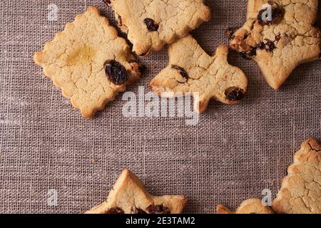 Chocolate cookies on linen napkin in the different shapes gluten-free, lactose-free, sugar-free, healthy dessert with raisins with copy space Stock Photo