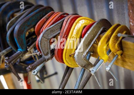 G-clamps arranged on workshop wall at the Oamaru Steam and Rail Restoration Society, South Island, New Zealand. Stock Photo