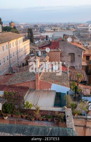 Aerial view over the rooftops of the historic residential district of Trastevere Rome, Italy, sloping down the Janiculum Hill towards the River Tiber Stock Photo