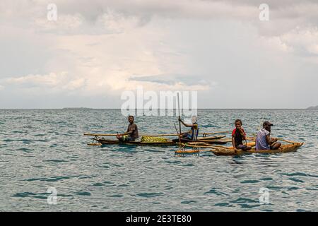 Outrigger Canoe in front of the True North at Panasia Island, Papua New Guinea Stock Photo