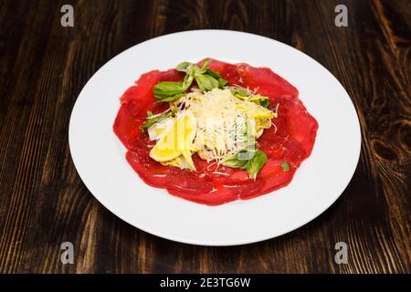 Veal carpaccio. Veal with lime and parmesan cheese. Top view. Free copy space. Stock Photo