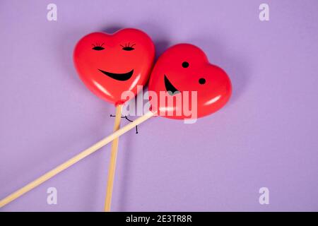hearts with drawn cupcakes lie on a purple background, happiness in love concept Stock Photo